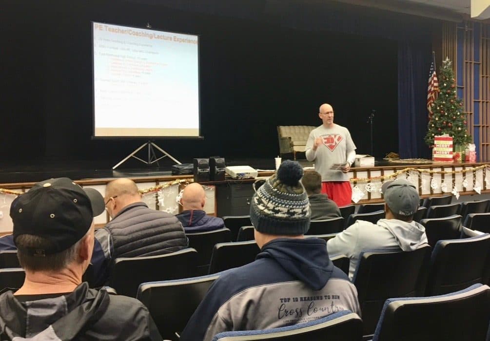 Coach Martens presenting to a school's coaching staff in an auditorium
