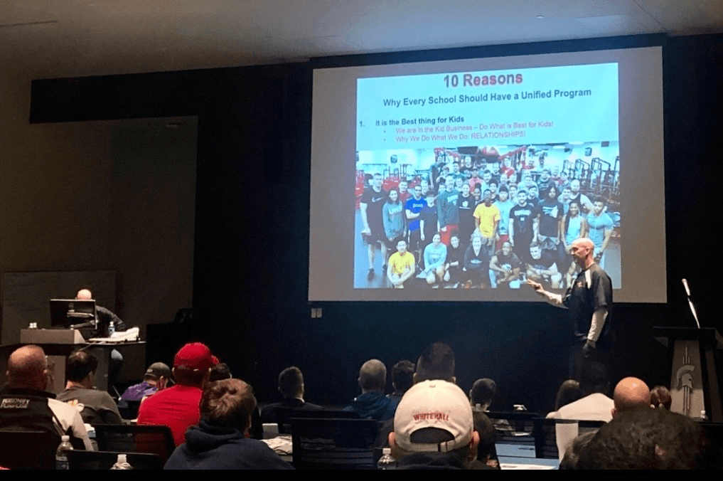 Coach Martens presenting to a room of coaches at a clinic