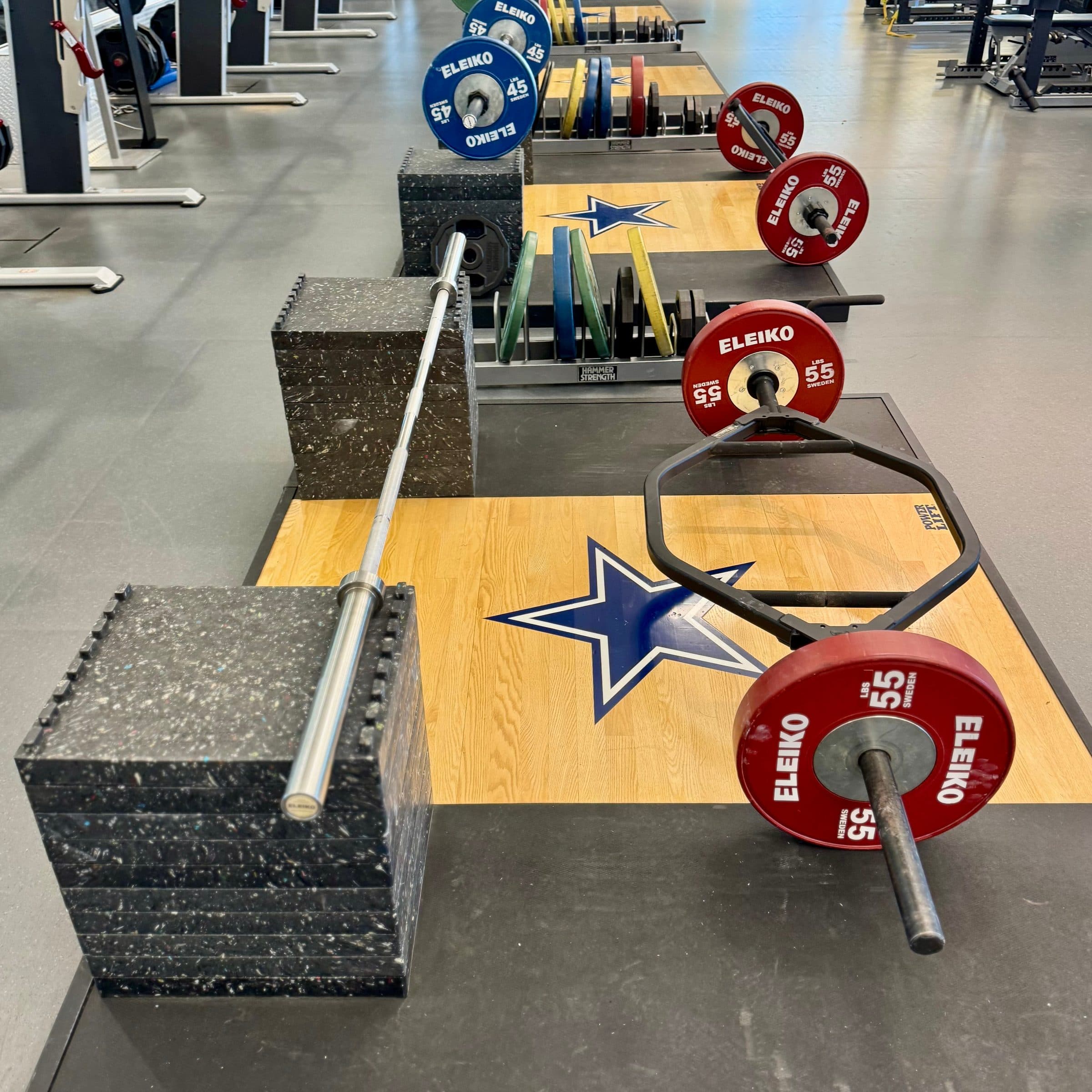 Lifting platforms marked with the Dallas Cowboys star in the team's weight room